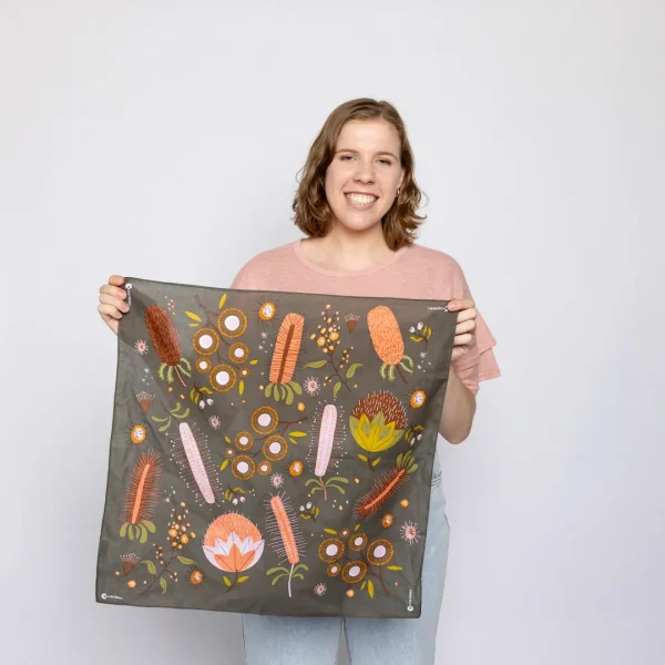 A person holding an Australian flora bandanna