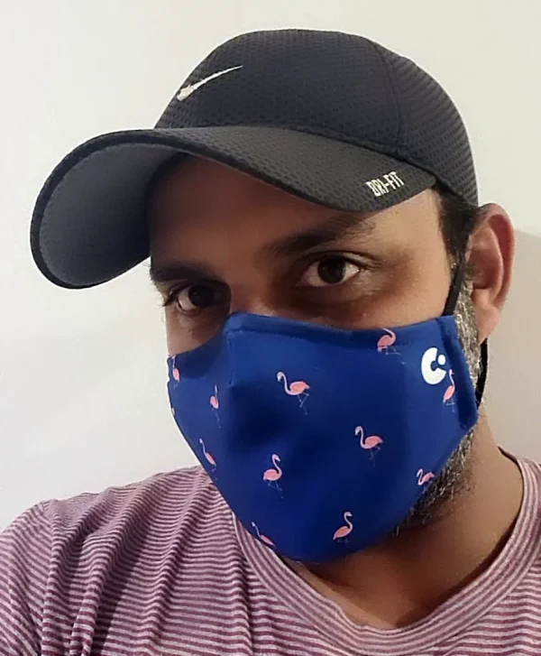 A person wearing a flamingo face mask