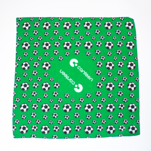 A wide shot photo of the green soccer bandana laid out flat