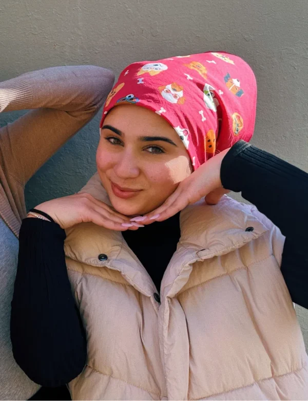 A person wearing a Magenta stylish dogs bandanna on their head