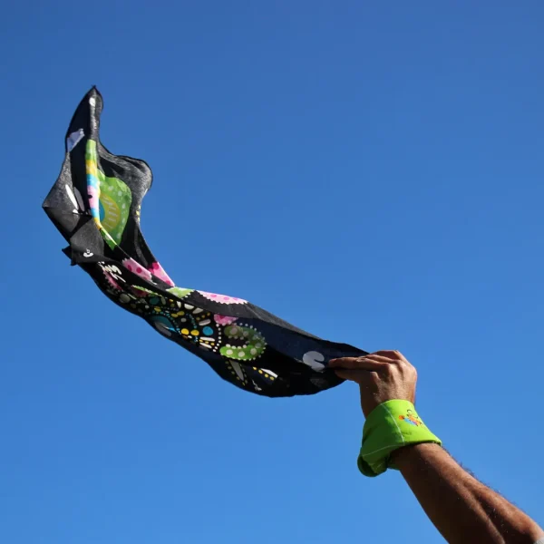 A person holding the Family Connections bandanna in the air