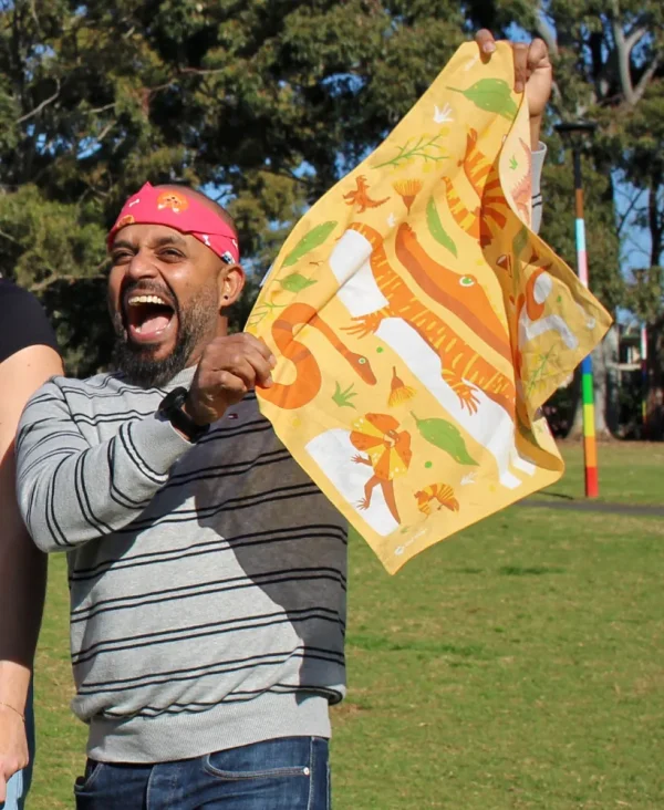 A person holding a Aussie Reptiles bandanna