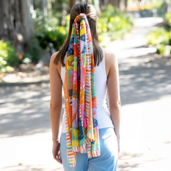 Young woman wearing the Dannii Minogue x Canteen silk modal scarf in hair